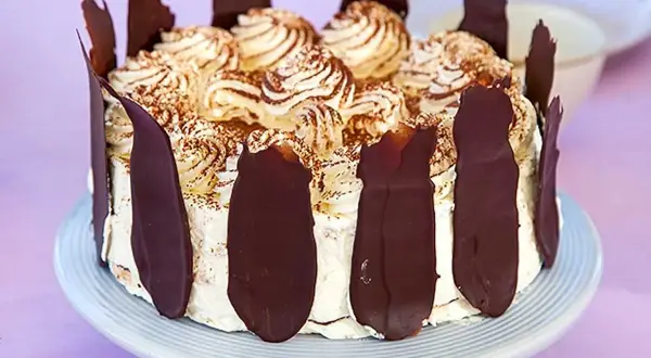 En läcker Schwarzwaldtårta glutenfri med vispgrädde, chokladspån och kakaopulver. Perfekt för alla chokladälskare!