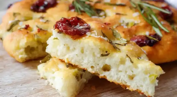 En saftig glutenfri focaccia med soltorkade tomater och rosmarin. Perfekt att baka glutenfritt till fikat.